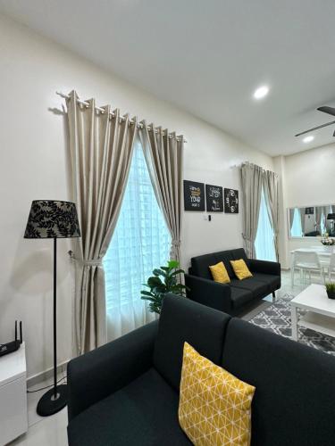 a living room with a couch and a table at RumahKu Homestay, Taman Jasin Perdana in Jasin