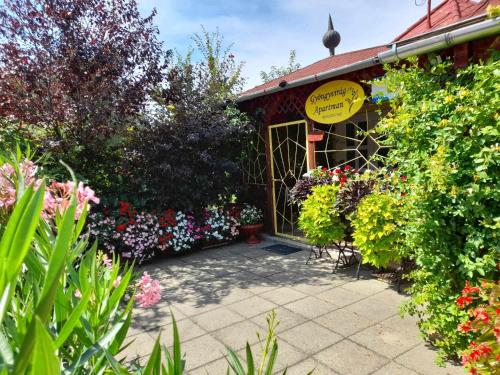 a flower shop with a bunch of flowers and plants at Gyöngyvirág Apartment in Romhány