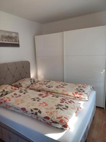 a bedroom with a bed with a comforter on it at EDIK in Velika Gorica