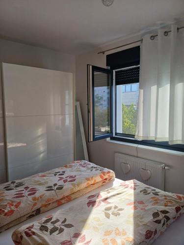 a bedroom with two beds and a window at EDIK in Velika Gorica