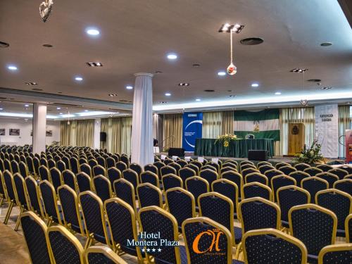 an empty hall with chairs and a stage in the background at Hotel Montera Plaza in Los Barrios