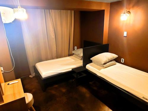 Ένα ή περισσότερα κρεβάτια σε δωμάτιο στο Good Guesthouse #2