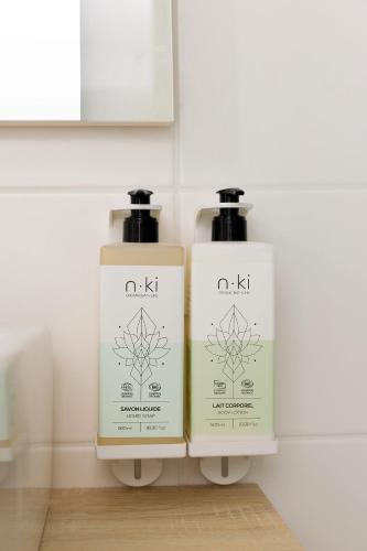 two bottles of soap sitting next to a wall at Hampton by Hilton Tours Centre, France in Tours
