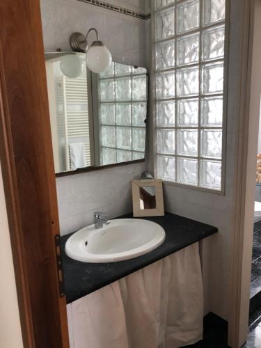 a bathroom with a sink and a mirror at Casa Tesor - your design home in Mantua city center in Mantova