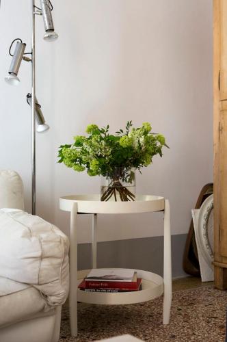a white table with a plant on top of it at Casa Tesor - your design home in Mantua city center in Mantova