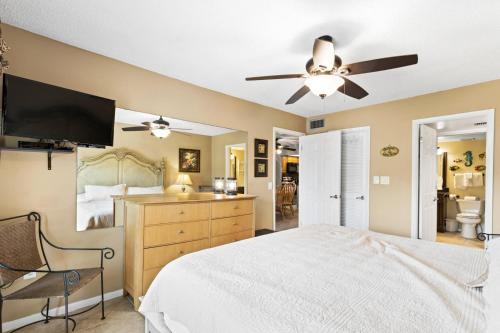 a bedroom with a bed and a ceiling fan at 208 Madeira Norte Condo in St Pete Beach