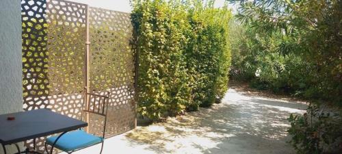 a patio with a fence and a table and chairs at Hôtel Villa Glanum et Spa in Saint-Rémy-de-Provence