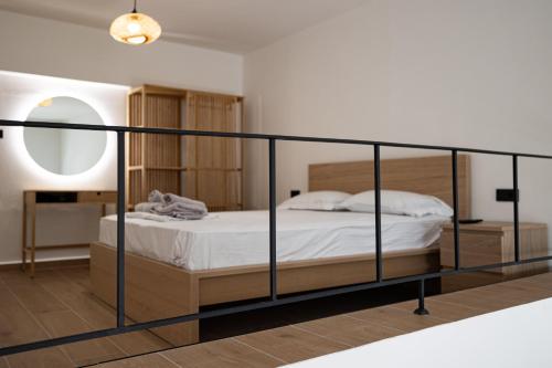 a bedroom with a bed with a black frame at Sogni D' Oro in Zakynthos Town