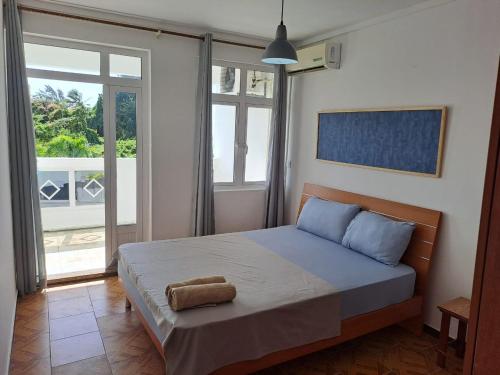 a bedroom with a bed with a towel on it at Spacious Three Bedroom Apartment in Grand Gaube
