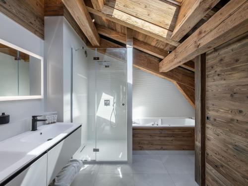 a bathroom with a shower and a sink and a tub at Chalet Luxe 12 Pers. Face aux Pistes avec Skiroom, Garage, Salle de Sport et Services Inclus - FR-1-569-19 in Demi-Quartier