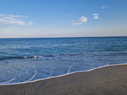 a beach with a body of water and the ocean at Domus Miky in Roccella Ionica
