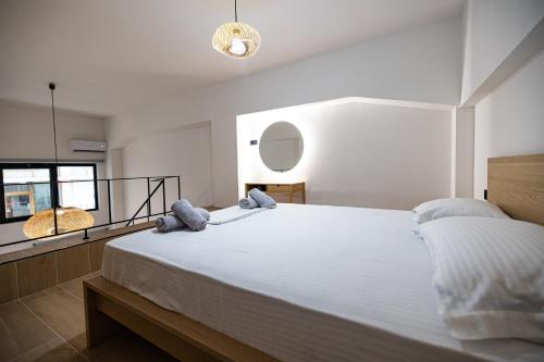 a bedroom with a large white bed and a window at Sogni D' Oro in Zakynthos Town