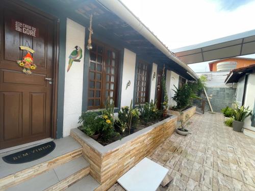 a front door of a building with plants on it at AP1 Atrás da passarela do caranguejo - Orla de Atalaia in Aracaju