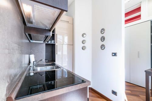 a kitchen with a sink and a counter at Easylife - Moderno rifugio in zona Bocconi in Milan