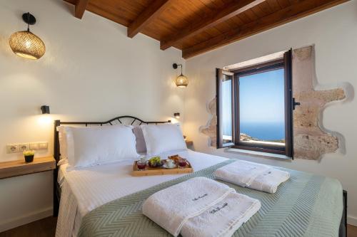 a bedroom with a bed with a tray of fruit on it at Historic Villa Kassiopi with Panoramic Sea view in Epáno Kefalás