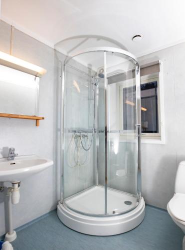 a bathroom with a shower and a sink at Lillehammer Camping in Lillehammer