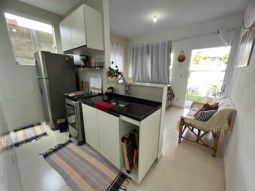 a kitchen with a sink and a stove top oven at Casa Aconchegante com Piscina Barra do Jacuípe in Camaçari