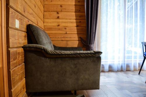 a chair in a room with a wooden wall at Hotel resort Sedula 