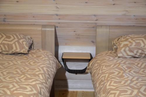 two beds sitting next to each other in a room at Hotel resort Sedula in Skogalis