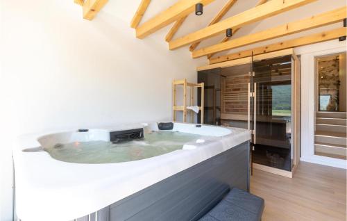 a bathroom with a large tub in a house at Stunning Home In Gospic With Outdoor Swimming Pool, Wifi And 2 Bedrooms in Gospić