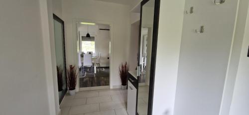 a hallway with a bathroom with a sink and a mirror at Vila Elena in Niš