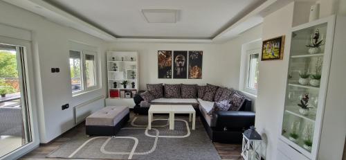 a living room with a couch and a table at Vila Elena in Niš