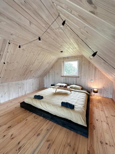 a bedroom with a large bed in a wooden ceiling at Sunset Village in Aglona