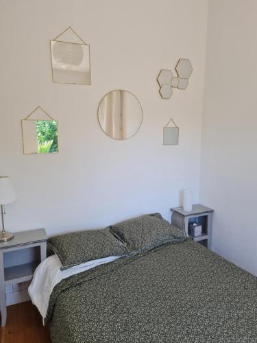 a bedroom with a bed and a desk and a mirror at Studio en plein centre-ville de Perros-Guirec in Perros-Guirec