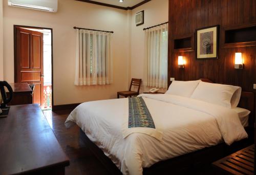 Giường trong phòng chung tại Pakhongthong Villa