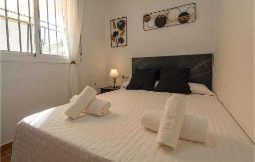 a bedroom with a large white bed with two towels at 4 Bedroom Gorgeous Home In Sedella in Sedella