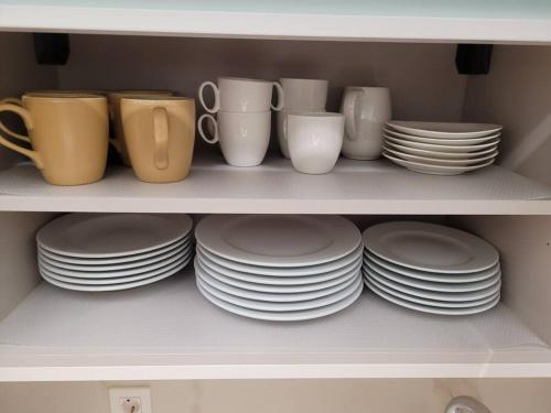 a shelf filled with plates and cups and dishes at Apartamento Azabache in Zaragoza