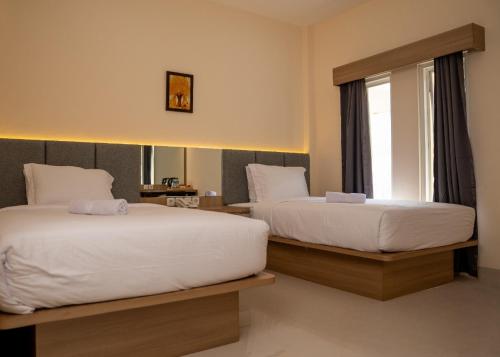 Llit o llits en una habitació de Hotel Luansa Klui