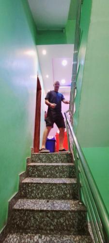 a man walking up a stairs in a building at Hotel Ananya Inn in Varanasi