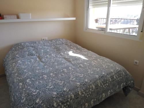 a bed in a bedroom with a blanket on it at Casa suerte in Algorfa