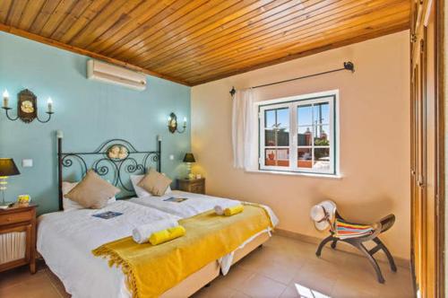 a bedroom with a large bed and a window at NEW! Poiso do Guincho by GalanteVasques in Carvoeiro