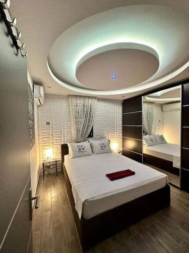 a bedroom with a large white bed with a round ceiling at Sevi House Suite in Thessaloniki