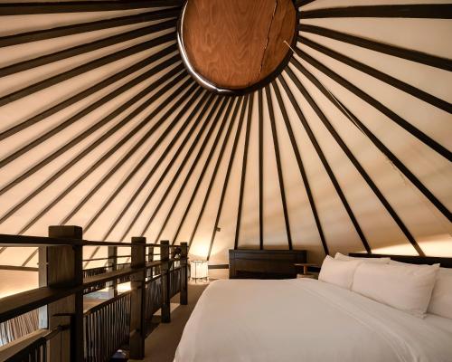 a room with a bed in a yurt at Patamma Hideaway Resort in Nan