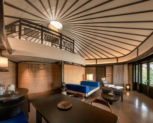 a living room with a blue couch and a table at Patamma Hideaway Resort in Nan