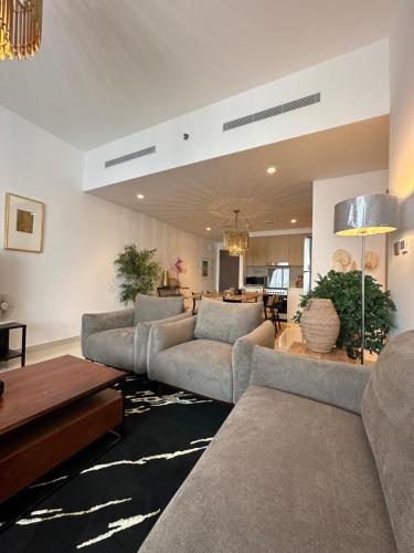 a large living room with couches and a table at ROYAL APARTMENTS DUBAI in Dubai