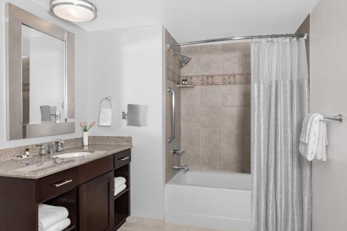 a bathroom with a shower and a sink and a tub at Marriott's Grand Chateau in Las Vegas