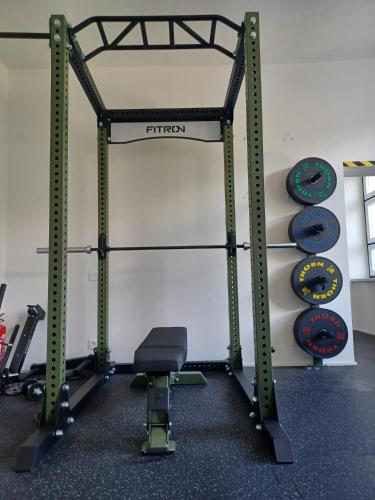 a gym with a bench and weights at Hotel Granit Nová Polianka*** - klimatické kúpele in Vysoké Tatry