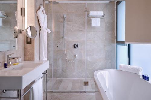 a bathroom with a shower and a toilet and a sink at Tunis Marriott Hotel in Tunis