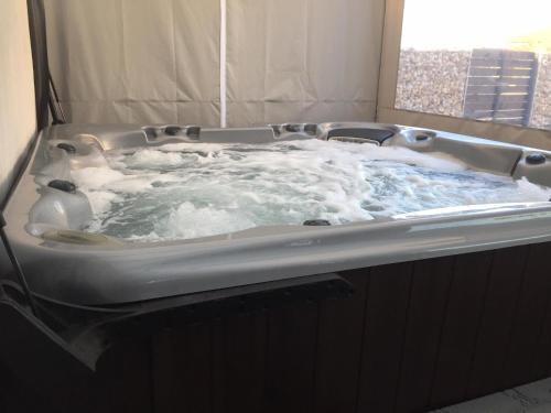 a jacuzzi tub with water in it at LURKÓ Apartmanok Siófok in Siófok