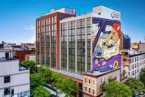 a building with a painting on the side of it at Moxy Brooklyn Williamsburg in Brooklyn