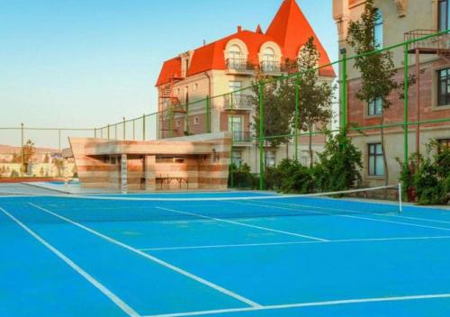 a tennis court in front of a building at Апартаменты у моря - в "Green City RESORT" in Baku