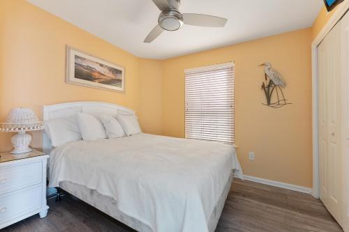 a bedroom with a white bed and a window at Nw Condo Across Beach Pool & Parking in North Wildwood