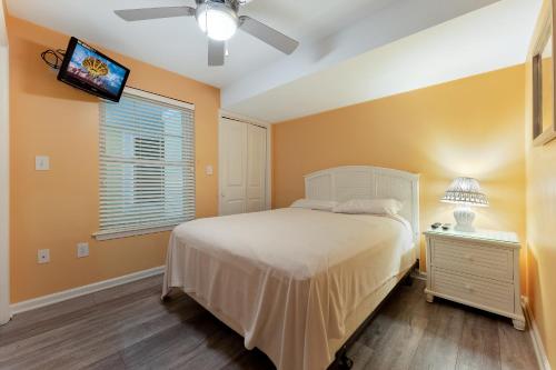 a bedroom with a bed and a tv on the wall at Nw Vacation Rental Condo W Pool & Ocean Views in North Wildwood