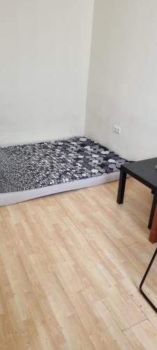 a room with a floor with a rug and a chair at Apartment free WiFi in Breitenau am Hochlantsch