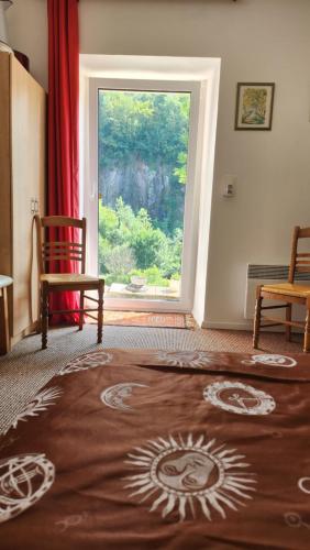 a living room with a large window and a rug at lovely apartment, gite, visit the vosges france in Fontenoy-le-Château