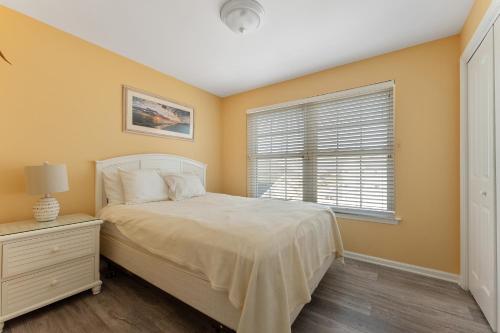 a bedroom with a bed and a window at Partial Ocean View Condo W Pool & Parking in North Wildwood